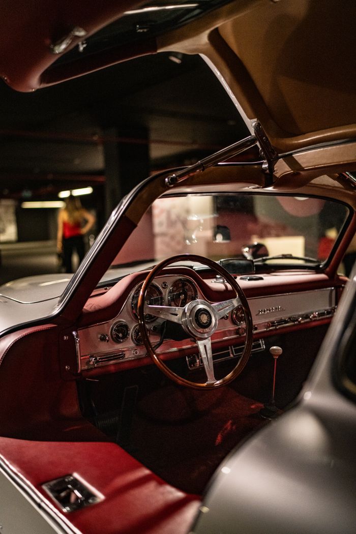Luxurious vintage car interior featuring a leather steering wheel and retro design elements.